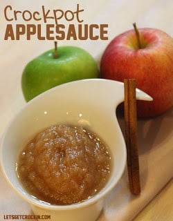 A bowl of fruit sitting on a table, with Apple and Sauce