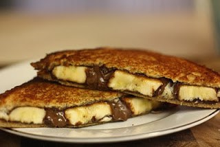A close up of a sandwich on a plate, with Chocolate and Bread