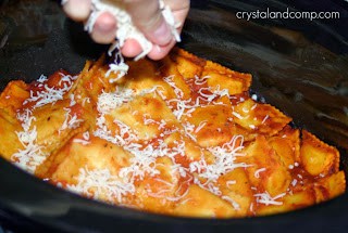 A person holding a pan of pizza, with Chicken and Ravioli