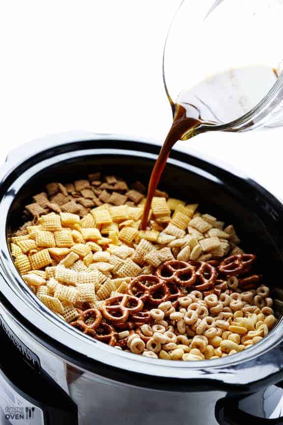 Slow cooker Chex mix ingredients in a black slow cooker pot