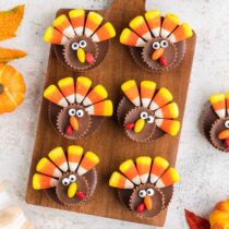 6 pieces of Candy Turkey lined up on wooden board.