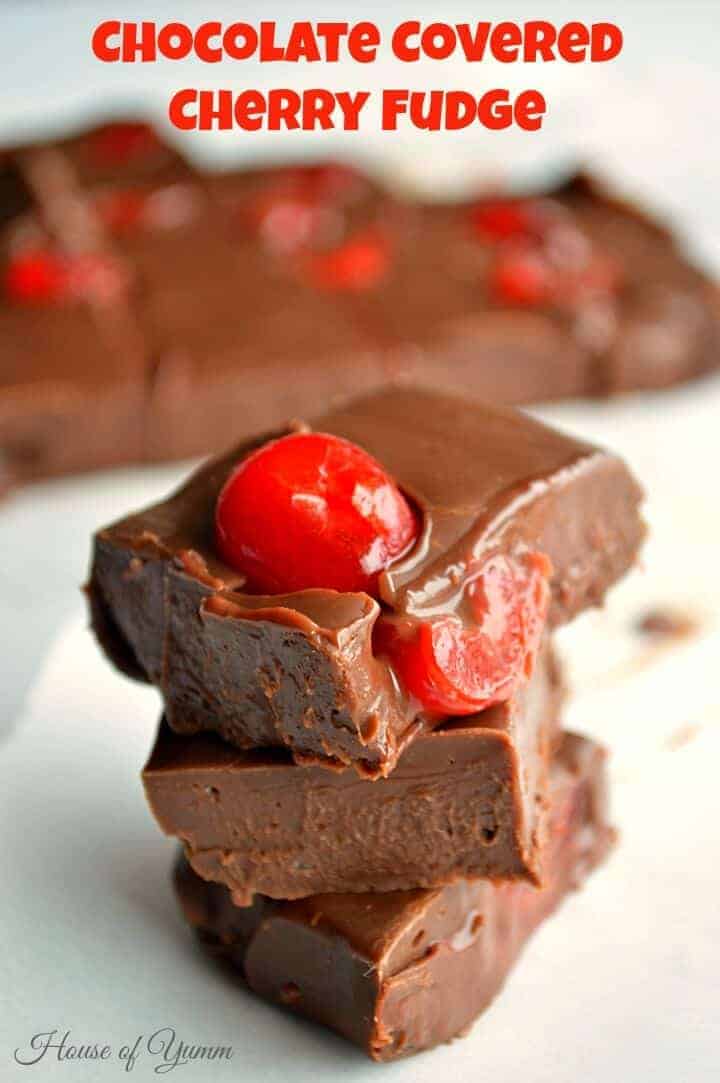 A piece of chocolate cake on a plate, with Fudge and Cherry
