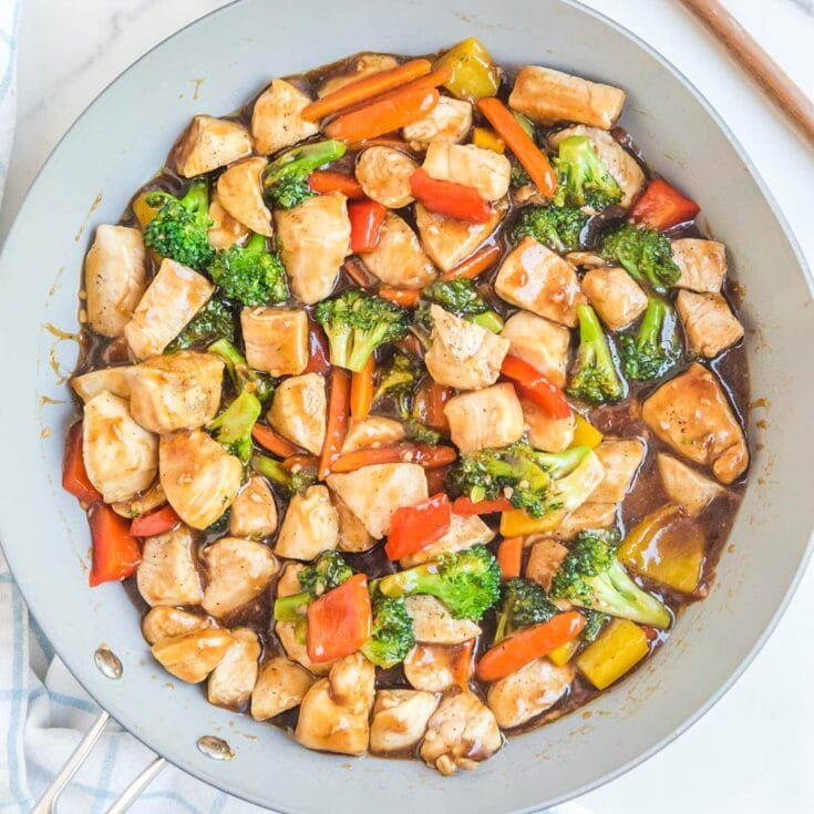 chicken stir fry in a pan.