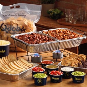 A pot of food on a table, with Qdoba