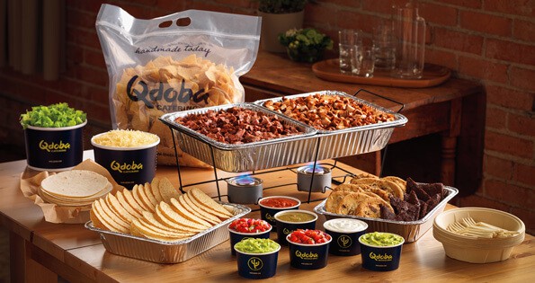 A pot of food on a table, with Qdoba