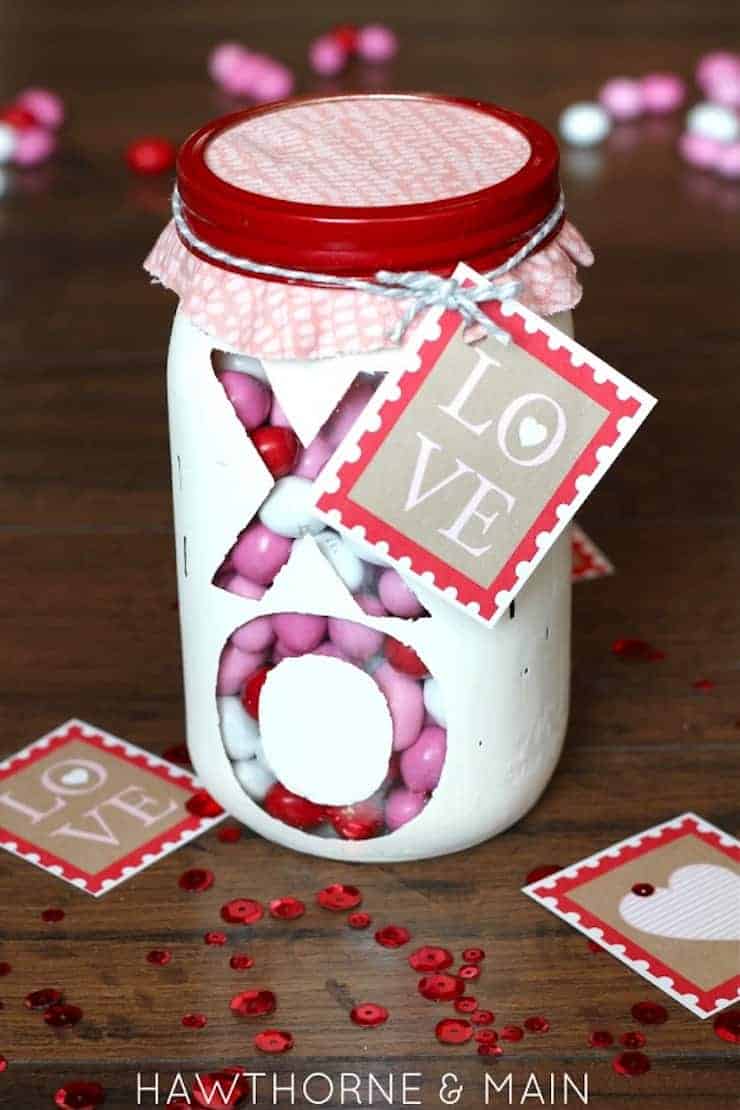 Mason jar painted with an XO on it filled with candy