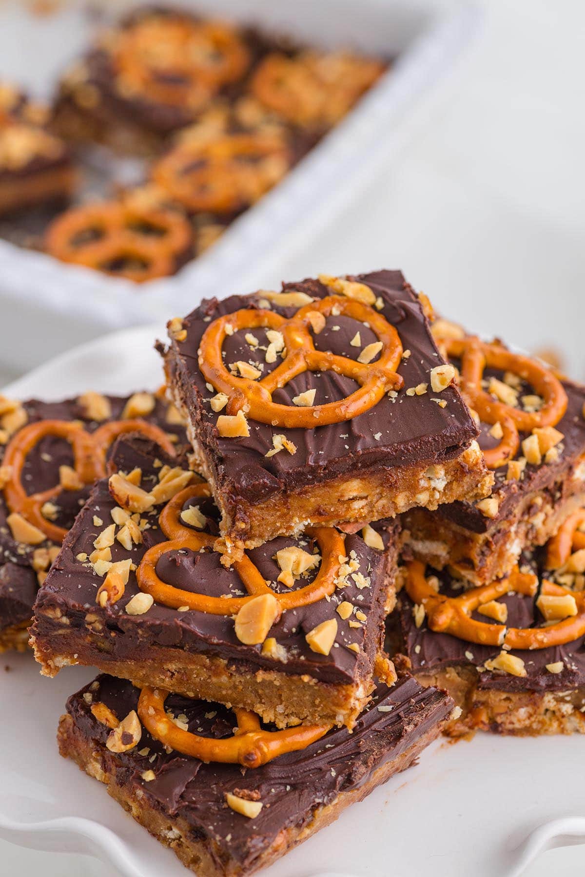 a couple of Chocolate Peanut Butter Pretzel Bars on a white plate.