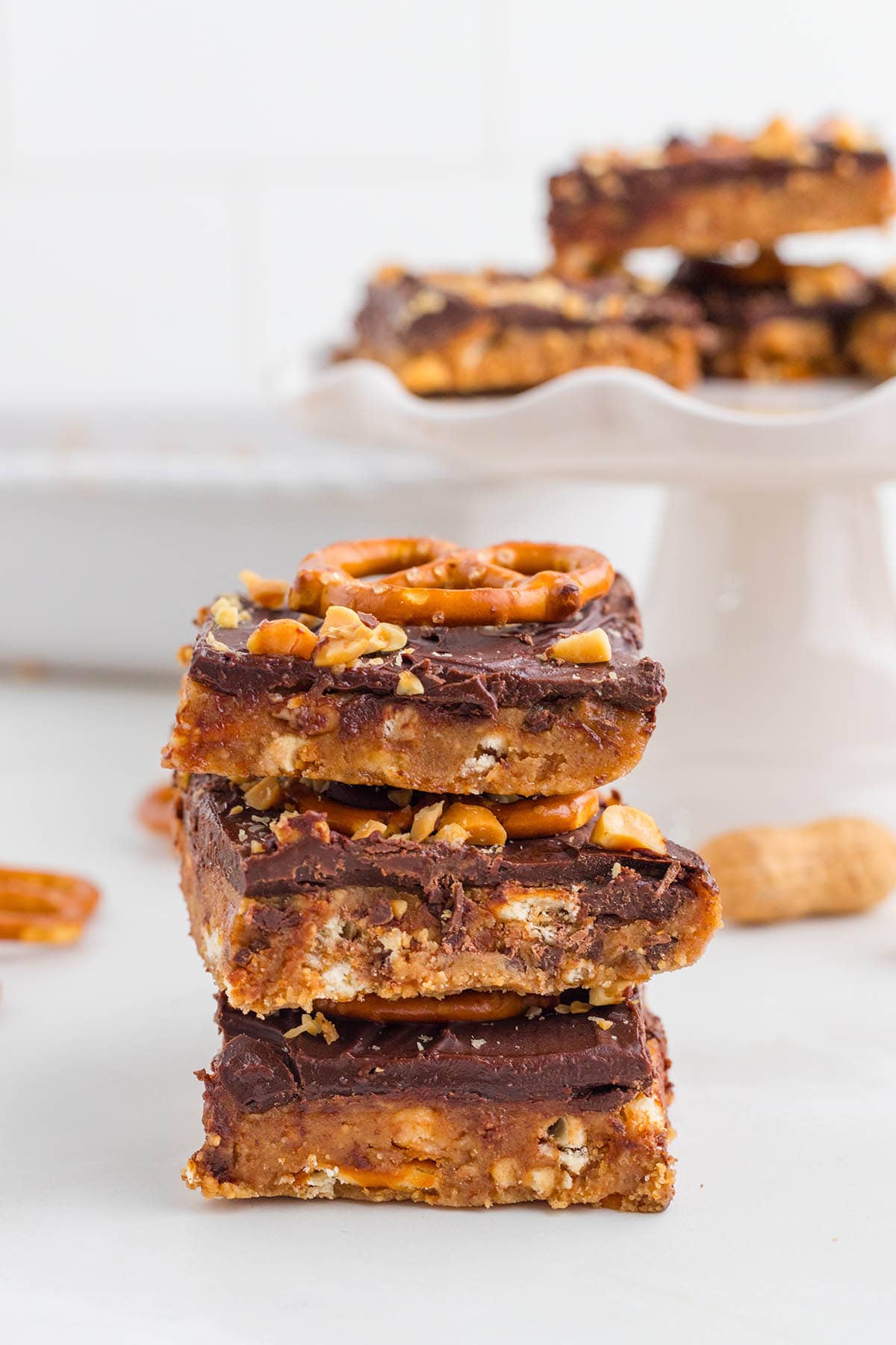 a stack of Chocolate Peanut Butter Pretzel Bars on the table.