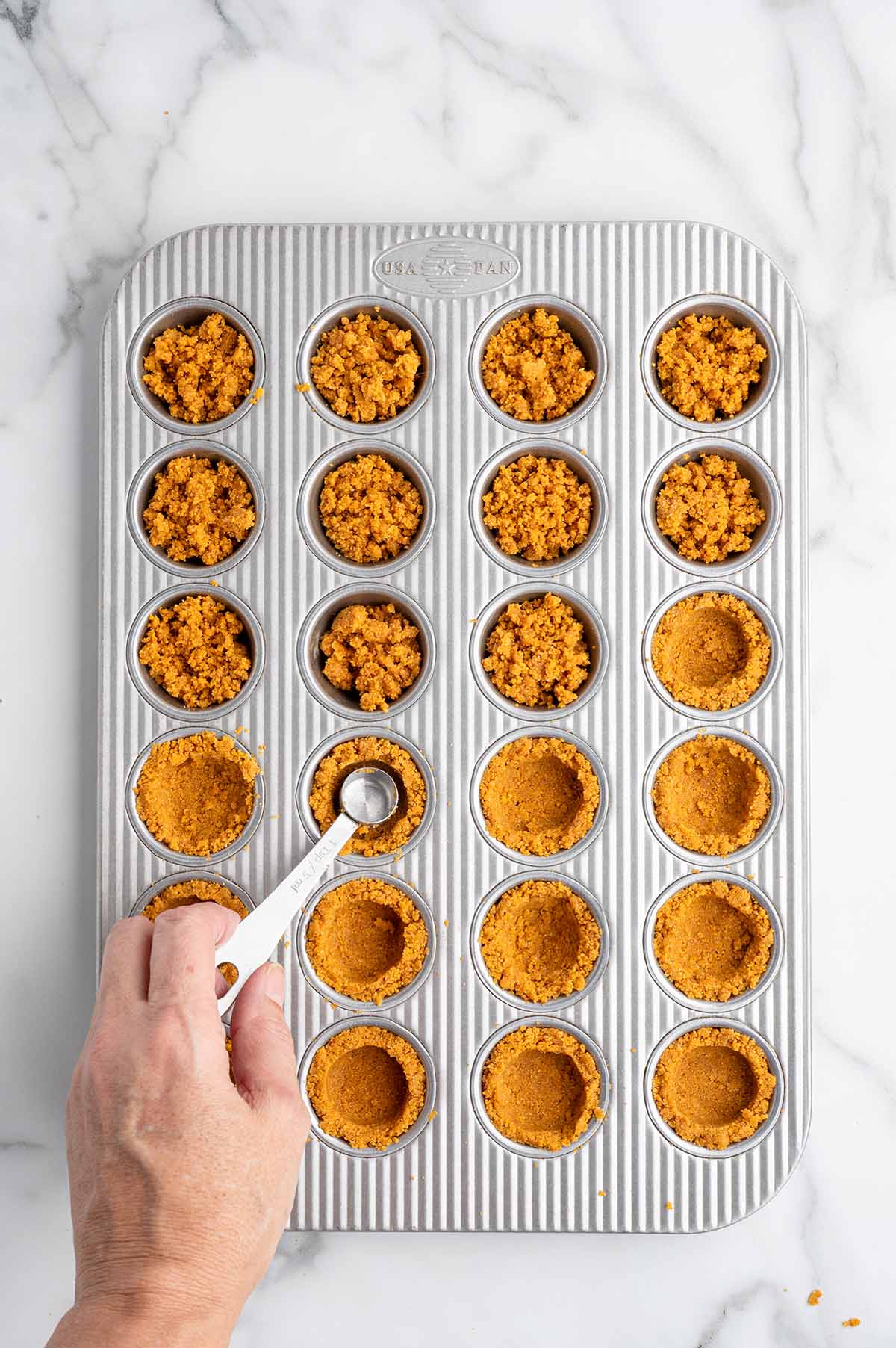fill the mini muffin cups with the graham cracker crumbs. 