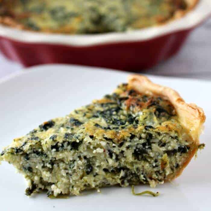 A close up of a plate of food with a slice of pizza, with Pie and Spinach