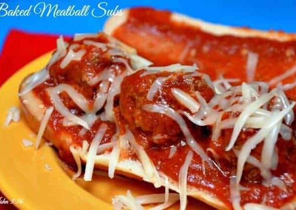 A close up of a plate of food with a slice of pizza, with Meatball