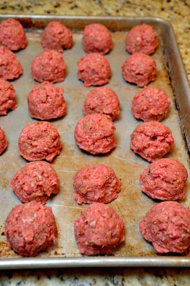 A close up of food on a grill, with Meatball and Sauce