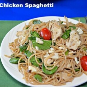 A plate of food on a table, with Chicken and Spaghetti