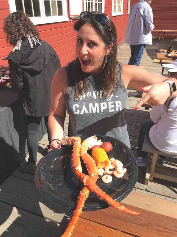 Girl pointing to a plate of crab legs