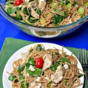 A plate of food on a table, with Spaghetti and Chicken