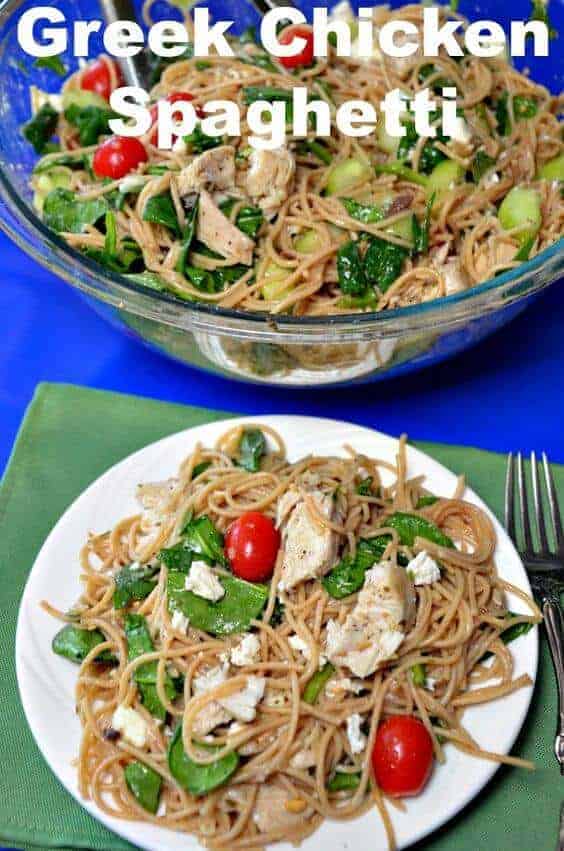 A plate of food on a table, with Spaghetti and Chicken