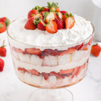 strawberry shortcake trifle with a couple fresh strawberries on top.