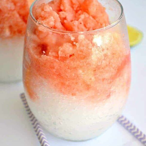A glass cup on a table, with Slush and Watermelon