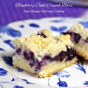 A piece of cake and ice cream on a plate, with Blueberry and Cobbler