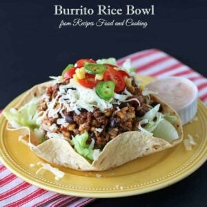 A plate of food on a table, with Bowl and Burrito