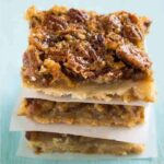 Pecan pie bars stacked up on top of each other
