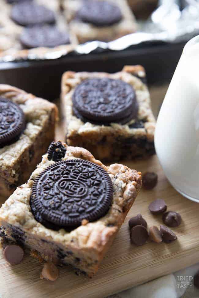 A close up of a cutting board with a cake, with Butter and Oreo