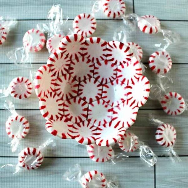 A peppermint candy bowl with peppermint spread around it