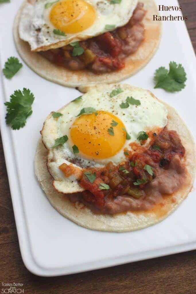 A plate of food on a table, with Egg and Huevos rancheros
