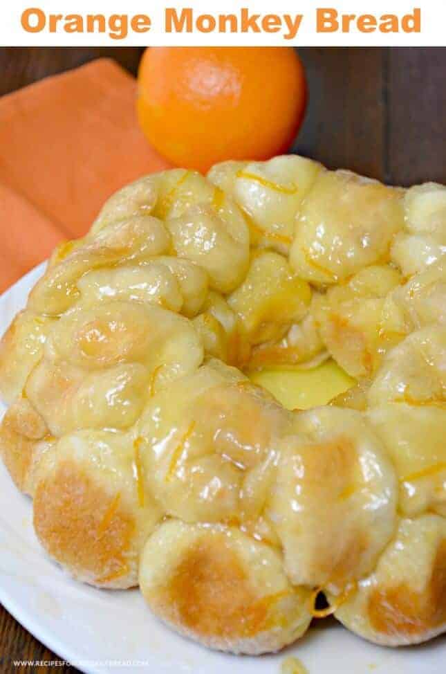 A banana and oranges on a plate, with Monkey bread