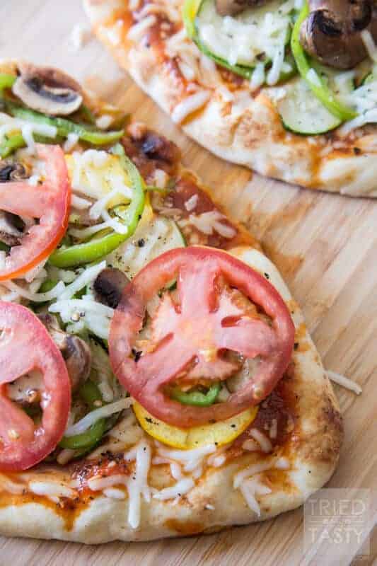 Grilled Veggie Flatbread Pizza -Looking for a low-cal dinner idea to use up some of those garden fresh veggies you've probably got in abundance? This pizza is perfect! It's tasty, is easy, and it's great for those watching their calories!