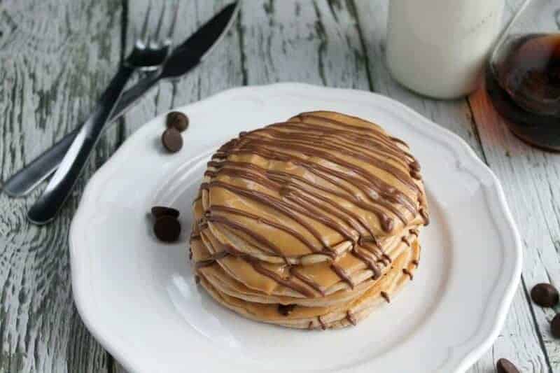 A plate with a piece of cake on a table, with Butter and Chocolate