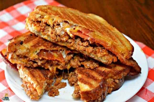 A sandwich and fries on a plate, with Bacon and Cheeseburger