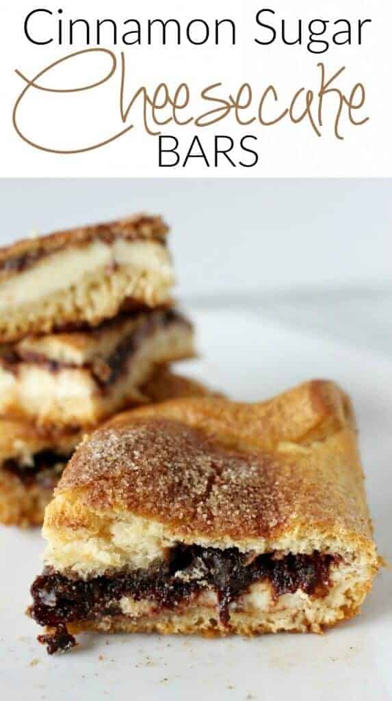 A close-up image of cinnamon sugar crescent cheesecake bars on a white plate