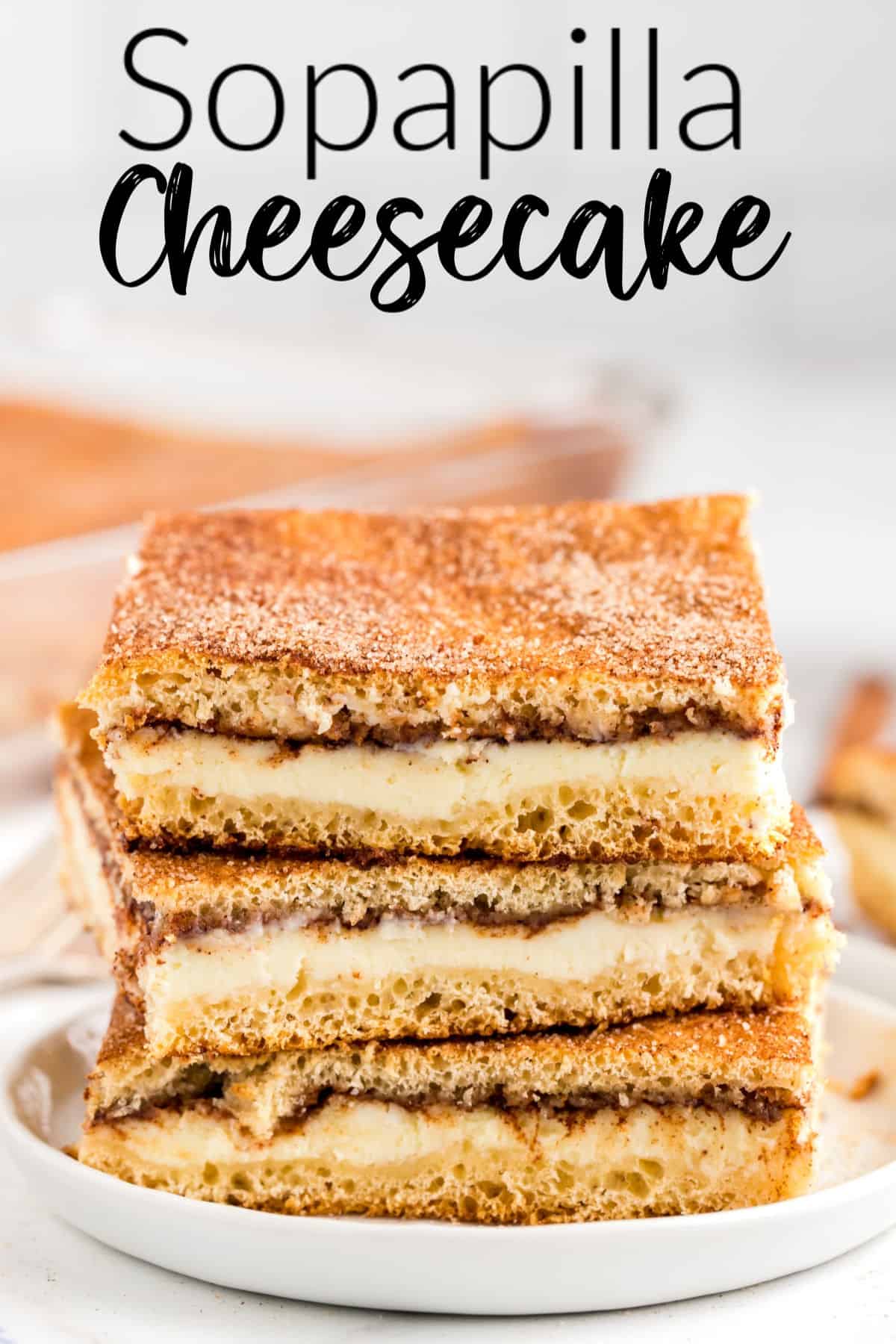 Sopapilla Cheesecake bars stacked on a white plate