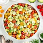 tomato cucumber avocado salad in a bowl.