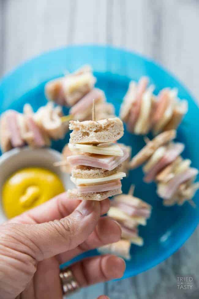 Mini turkey ham and cheese sandwiches and a toothpick