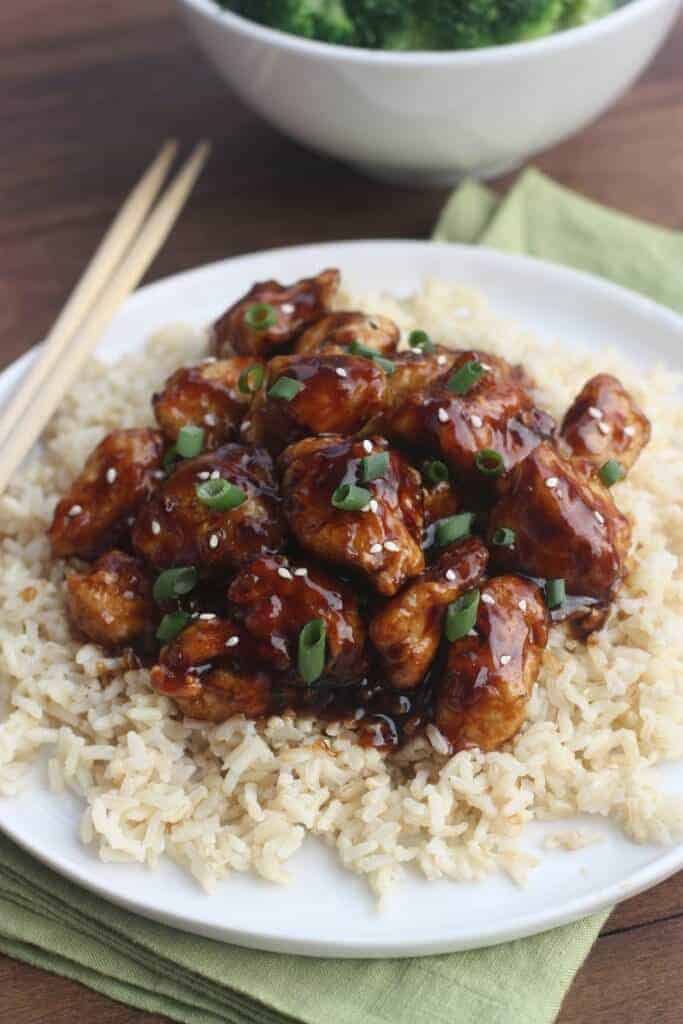 A plate of food with rice meat and vegetables