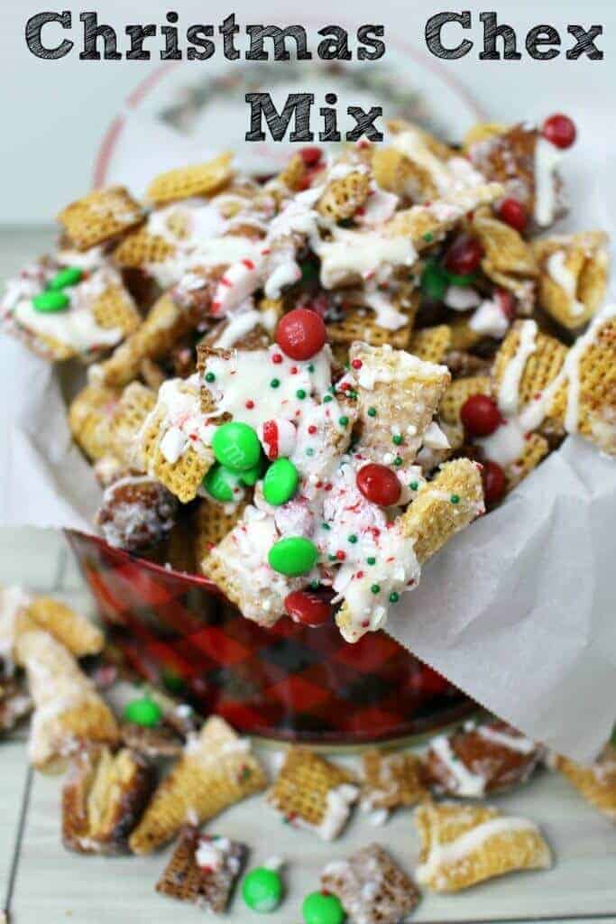 A close up of chex mix with white chocolate and Christmas colored sprinkles and red and green M&Ms