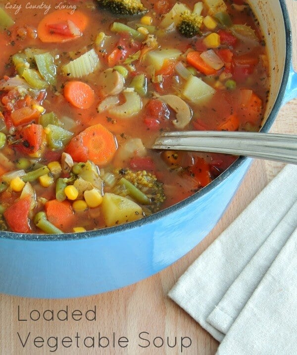 A bowl of soup and a spoon, with Vegetable soup