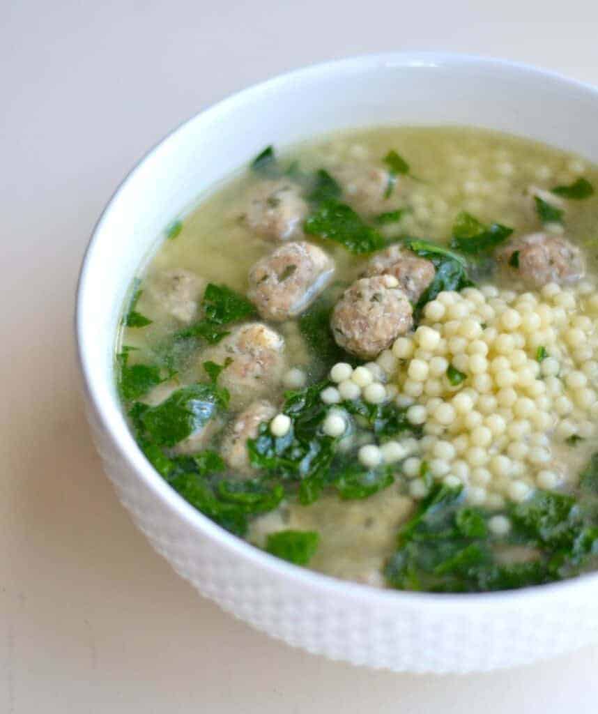 A bowl of food with broccoli, with Wedding soup