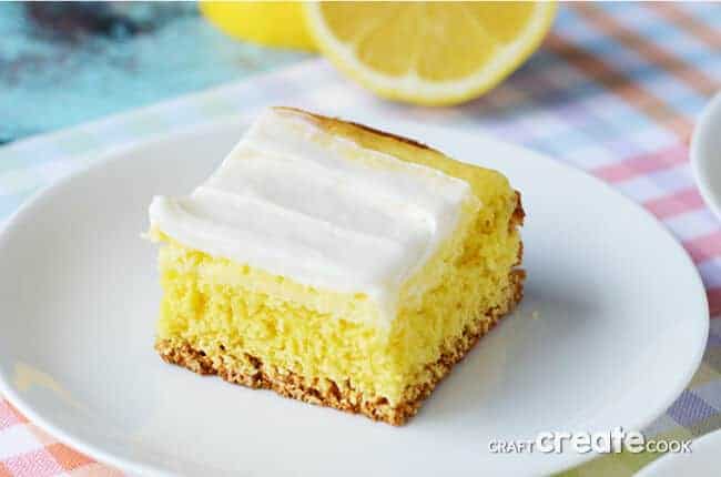 A piece of cake on a plate, with Lemon and Cream
