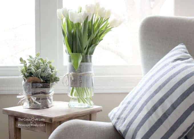 A room filled with furniture and vase of flowers on a table