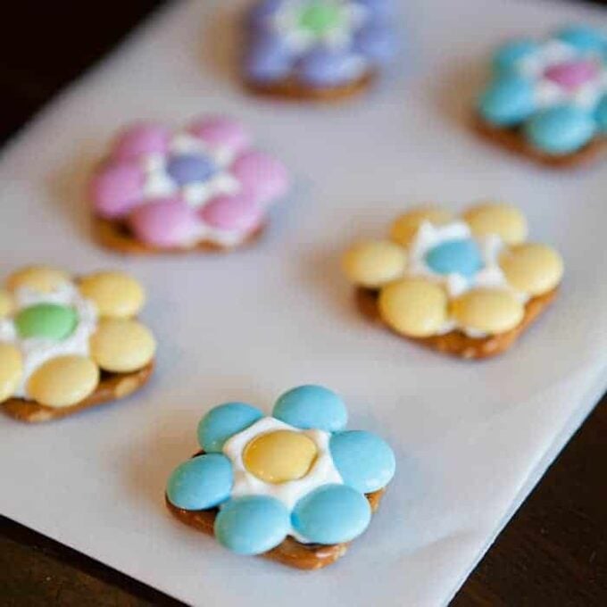 A close-up of pretzels with M&Ms and candy melts to look like flowers