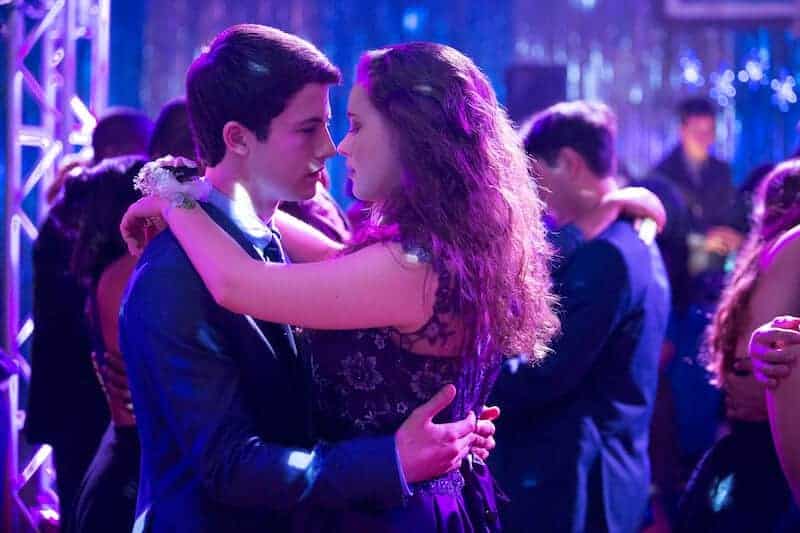 A man and a woman standing on a stage, with 13 Reasons Why
