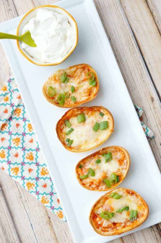 Mini Chicken Enchiladas Cups are the perfect two bite appetizer! Cheesy, easy, and full of Mexican flavors, these are perfect for any party or event!