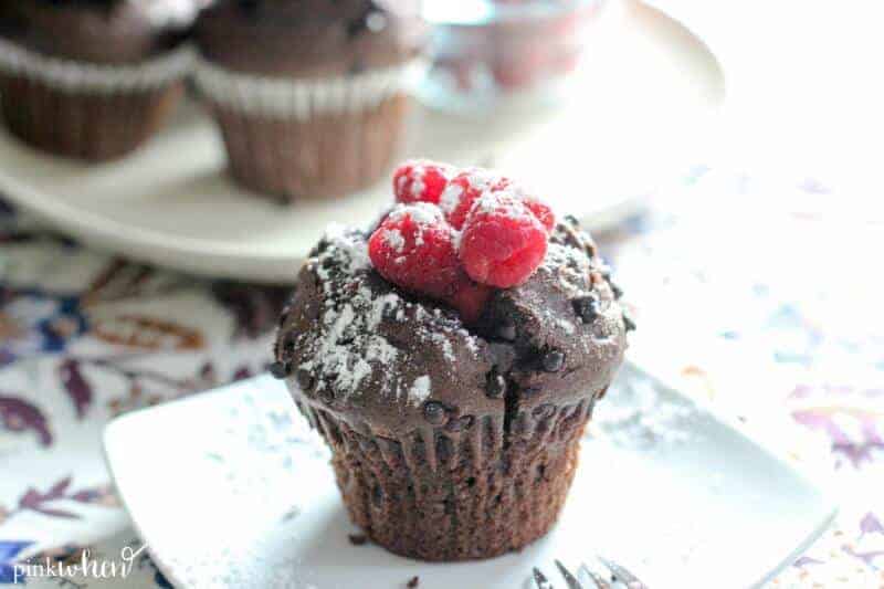 chocolate raspberry breakfast muffins with fresh raspberries and powdered sugar