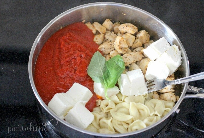 A bowl of food, with Chicken and Cheese