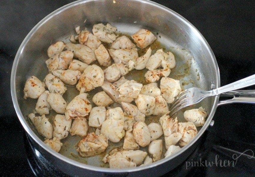 A bowl of food cooking on a stove