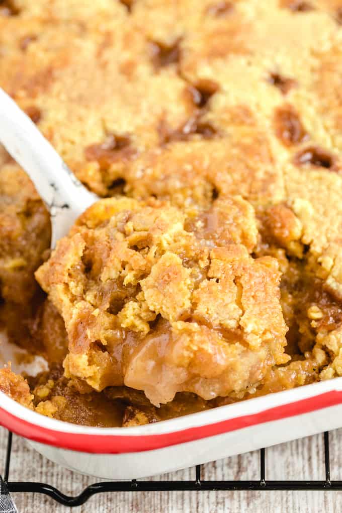 Dump Cake scooping out of baking dish