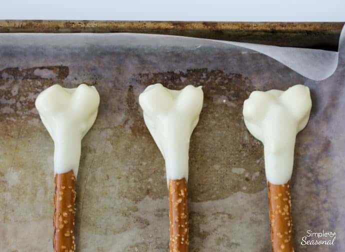 Dip the marshmallows and pretzels in chocolate